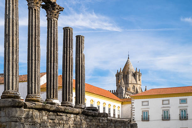Photo of ancient Roman ruins, highlighted by the columns, inside the town of Evora in Portugal, one of the main tourist sights of the city.